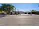A well-maintained home with desert landscaping, a spacious driveway, and a unique side gate at 14012 N 57Th Pl, Scottsdale, AZ 85254