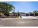 A well-maintained home with desert landscaping, a spacious driveway, and a unique side gate at 14012 N 57Th Pl, Scottsdale, AZ 85254