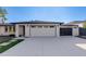 The front of the property showcases a clean white garage door and a modern driveway design at 14012 N 57Th Pl, Scottsdale, AZ 85254