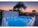 Relaxing hot tub with blue lighting, a tranquil oasis for relaxation and rejuvenation under the evening sky at 14012 N 57Th Pl, Scottsdale, AZ 85254