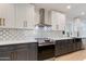 Modern kitchen with white cabinets, sleek countertops, stainless steel appliances, and decorative backsplash at 14012 N 57Th Pl, Scottsdale, AZ 85254