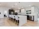 Spacious kitchen with a large island, counter seating, modern cabinets, and stainless steel appliances at 14012 N 57Th Pl, Scottsdale, AZ 85254