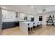 Updated kitchen featuring white cabinets, a large island, stainless steel appliances, and decorative backsplash at 14012 N 57Th Pl, Scottsdale, AZ 85254