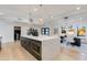 Open concept kitchen with a large island, modern appliances, pendant lighting, and a bright dining area at 14012 N 57Th Pl, Scottsdale, AZ 85254