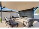 Inviting outdoor patio features modern seating, sleek fireplace, and neutral-toned pavers for stylish relaxation at 14012 N 57Th Pl, Scottsdale, AZ 85254