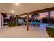 Covered patio and outdoor lounge seating overlooking a sparkling pool and landscaped backyard at 14012 N 57Th Pl, Scottsdale, AZ 85254