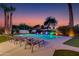 Lounge chairs surround a backyard pool at sunset at 14012 N 57Th Pl, Scottsdale, AZ 85254