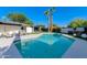 Sparkling pool surrounded by lounge chairs and lush landscaping, creating a serene outdoor oasis at 14012 N 57Th Pl, Scottsdale, AZ 85254