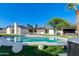 Resort style pool with pristine landscaping, ample seating and blue skies, perfect for relaxation and entertainment at 14012 N 57Th Pl, Scottsdale, AZ 85254