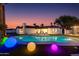 Backyard pool with lounge chairs and radiant lighting, perfect for evening relaxation and outdoor entertainment at 14012 N 57Th Pl, Scottsdale, AZ 85254