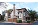 Stylish townhome with a private garage and well-maintained landscaping creates an inviting curb appeal at 14250 W Wigwam Blvd # 1723, Litchfield Park, AZ 85340