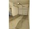 A spacious two car garage with concrete floors and an automatic garage door at 14250 W Wigwam Blvd # 1723, Litchfield Park, AZ 85340