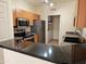 Modern kitchen boasts stainless steel appliances, granite countertops, and adjacent laundry area at 14250 W Wigwam Blvd # 1723, Litchfield Park, AZ 85340