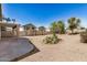 Large backyard with desert landscaping, privacy fence, and covered patio is perfect for relaxation at 1501 S 122Nd Ave, Avondale, AZ 85323