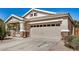 Charming home featuring a two-car garage, stone accents, and a lovely front porch, all under a sunny sky at 1501 S 122Nd Ave, Avondale, AZ 85323