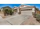 Inviting exterior showcasing a two-car garage, a well-maintained driveway and desert landscaping with a beautiful cactus at 1501 S 122Nd Ave, Avondale, AZ 85323