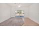 Bright, airy living space with tiled floors and carpet, leading to a sliding glass door and a view of the backyard at 1501 S 122Nd Ave, Avondale, AZ 85323