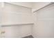 This walk-in closet is equipped with shelves and chrome closet rods at 1501 S 122Nd Ave, Avondale, AZ 85323