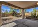 Inviting backyard with a covered patio area, rock landscaping, and mature trees for a serene outdoor retreat at 1641 W Windsong Dr, Phoenix, AZ 85045