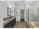 Bathroom featuring dual sinks, granite countertops, tile flooring, and a separate shower at 1641 W Windsong Dr, Phoenix, AZ 85045