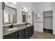 Bathroom featuring dual sinks, granite countertops, tile flooring, and bright lighting at 1641 W Windsong Dr, Phoenix, AZ 85045