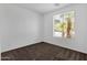 Bright bedroom featuring a large window with a view, carpeted floors, and neutral walls ready for personalization at 1641 W Windsong Dr, Phoenix, AZ 85045