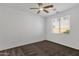 Bedroom with carpeted floors, ceiling fan, and a large window providing ample natural light and outdoor views at 1641 W Windsong Dr, Phoenix, AZ 85045