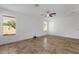 Bedroom featuring neutral walls, a ceiling fan, tile flooring, and bright windows at 1641 W Windsong Dr, Phoenix, AZ 85045