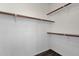 Spacious walk-in closet featuring ample shelving and storage for an organized wardrobe and personal belongings at 1641 W Windsong Dr, Phoenix, AZ 85045