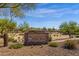 Stone community sign reading 'Foothills Club West' framed by desert landscaping and mature trees on a sunny day at 1641 W Windsong Dr, Phoenix, AZ 85045