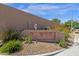 Stone community sign reading 'Desert Winds' is framed by desert landscaping on a sunny day at 1641 W Windsong Dr, Phoenix, AZ 85045