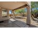 Covered patio with large columns overlooks a well-maintained, gravel-filled yard with desert landscaping at 1641 W Windsong Dr, Phoenix, AZ 85045