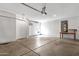 Spacious garage featuring high ceilings, ample room for parking, and a functional workbench at 1641 W Windsong Dr, Phoenix, AZ 85045