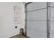Well-organized garage interior featuring an open garage door, pegboard and hooks for storage, and clean cement flooring at 1641 W Windsong Dr, Phoenix, AZ 85045