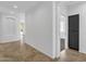 Open hallway offering neutral walls and floors, and access to other rooms at 1641 W Windsong Dr, Phoenix, AZ 85045