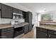 Modern kitchen with sleek cabinetry, stainless steel appliances, and granite countertops at 1641 W Windsong Dr, Phoenix, AZ 85045