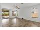 Bright living room with tile floors, ceiling fan, and access to outdoor living space at 1641 W Windsong Dr, Phoenix, AZ 85045