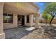 Relaxing covered patio area with an opening to the backyard oasis for outdoor enjoyment and entertaining at 1641 W Windsong Dr, Phoenix, AZ 85045