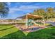 Shaded community playground includes slides, climbing area and park bench seating at 1641 W Windsong Dr, Phoenix, AZ 85045