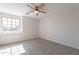 Bright bedroom features a ceiling fan and a window with sunlight at 16609 S 41St St, Phoenix, AZ 85048