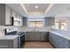Renovated kitchen featuring quartz countertops, stainless steel appliances, and gray cabinetry at 16609 S 41St St, Phoenix, AZ 85048