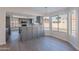 Bright eat-in kitchen features gray cabinets, quartz countertops, and a window view to the pool at 16609 S 41St St, Phoenix, AZ 85048