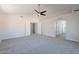 Spacious main bedroom with carpet, ceiling fan, and dual walk-in closets leading to ensuite at 16609 S 41St St, Phoenix, AZ 85048