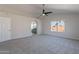 Spacious main bedroom with carpet, ceiling fan, and ensuite bathroom featuring a separate commode at 16609 S 41St St, Phoenix, AZ 85048