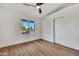 Bright bedroom featuring wood-look floors, window, closet, and ceiling fan at 1720 W Highland St, Chandler, AZ 85224