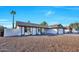Single-story home boasting a xeriscaped front yard and a painted privacy wall at 1720 W Highland St, Chandler, AZ 85224