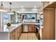 Bright kitchen featuring stainless steel appliances, a large window, and a spacious quartz countertop island at 1720 W Highland St, Chandler, AZ 85224