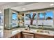Well-lit kitchen with a big window, modern backsplash, stainless steel appliances, and open shelving at 1720 W Highland St, Chandler, AZ 85224