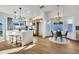 Modern kitchen with a waterfall island, breakfast bar, and open layout with dining area at 1720 W Highland St, Chandler, AZ 85224