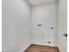 Small laundry room with vinyl floors and utility connections on the white wall at 1720 W Highland St, Chandler, AZ 85224